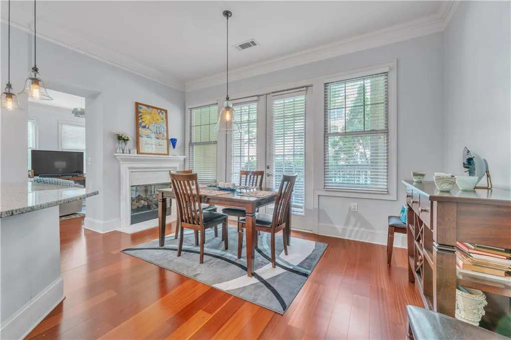 Dining room featuring wood-type flooring and ornamental molding