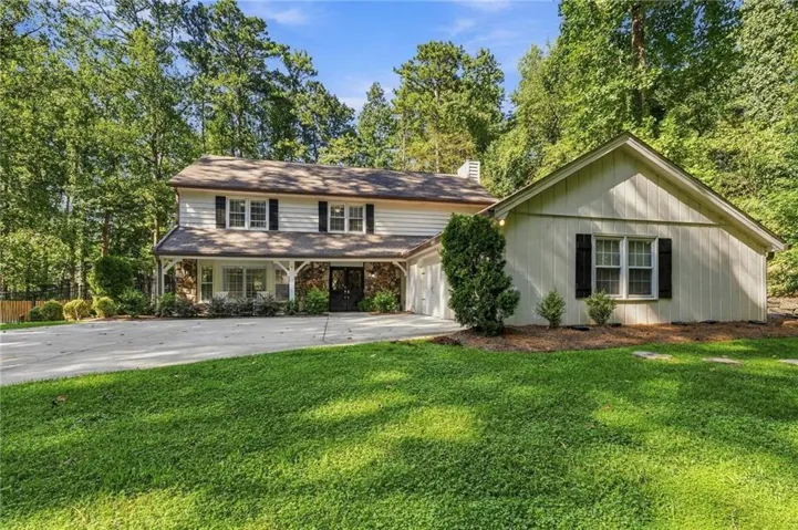 Two-story residence with a covered front porch and stone accents