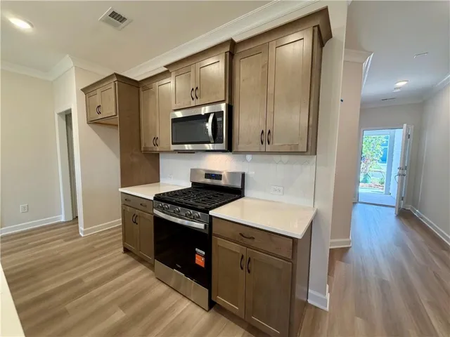 Stunning kitchen with Stained maple cabinets & black hardware -