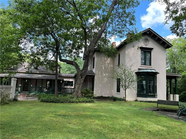 Back of property featuring a yard and stucco siding