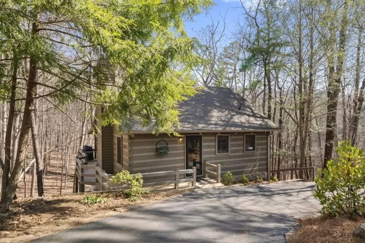 View of front of house with a shingled roof