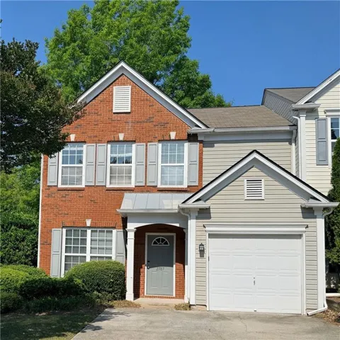 Brick and siding exterior featuring white trim and gray shutters