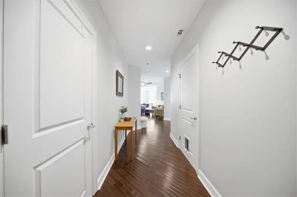Hall with recessed lighting and dark wood-style floors