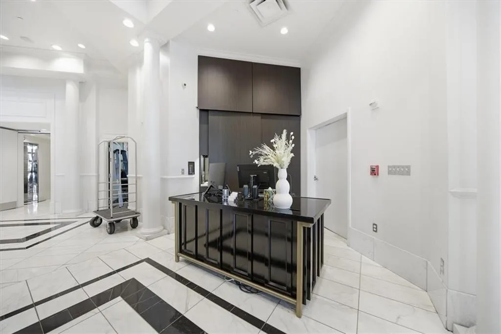 Corridor featuring recessed lighting, a high ceiling, and inlaid floor details