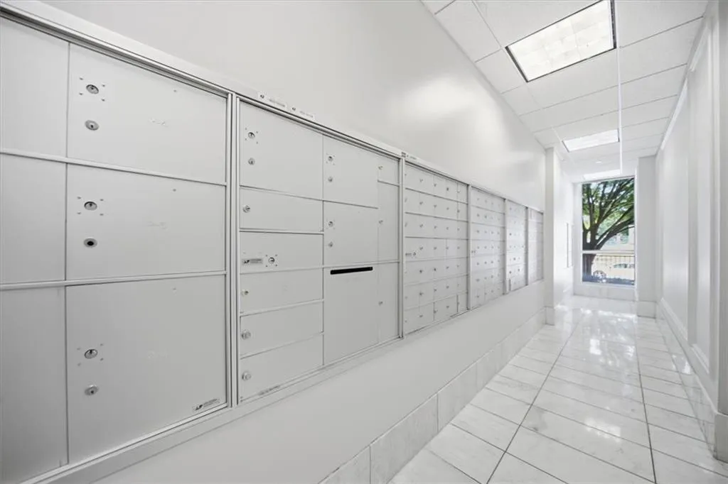 View of home's community featuring mail area and a drop ceiling