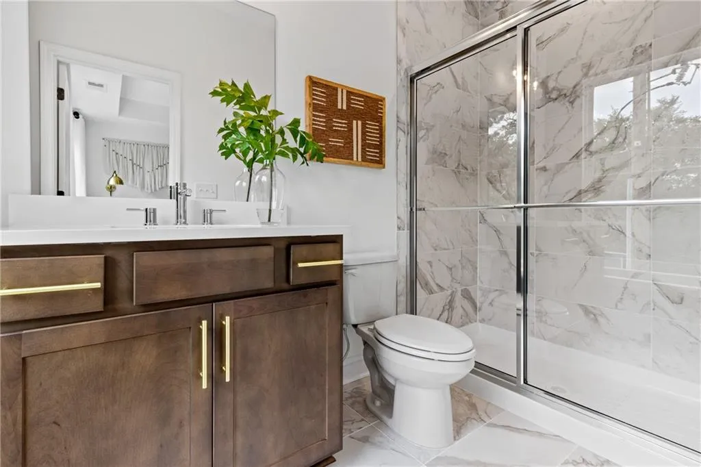 Full bathroom attached to Secondary bedroom. Pictures are of model home
