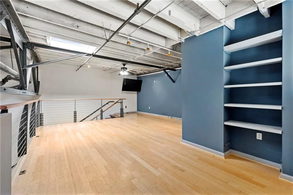 Below grade area featuring a ceiling fan and light wood-style flooring