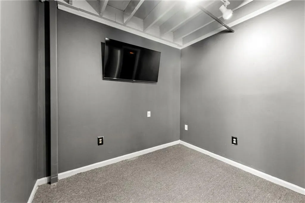 Carpeted empty room featuring baseboards