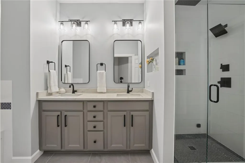 The master suite offers a tranquil retreat with a fully re-built spa bath showcasing a dramatic steam shower, jetted tub and quartzite vanity.