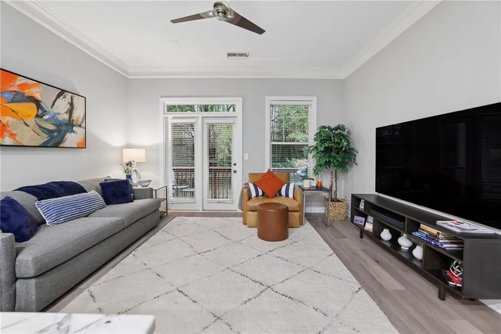 Living room opens to private rear balcony.