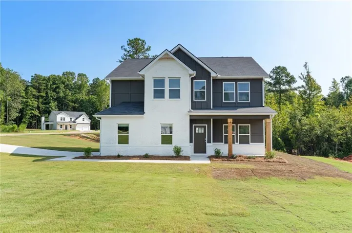 Two-story residential structure featuring white brick and dark siding