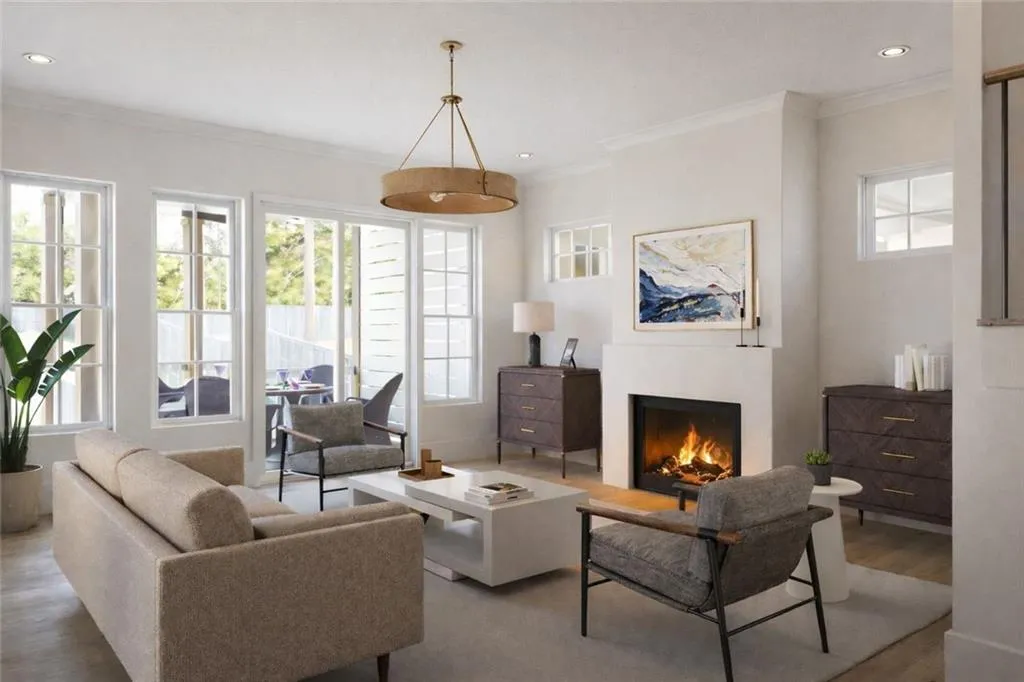 Living area featuring crown molding, wood finished floors, recessed lighting, and a lit fireplace