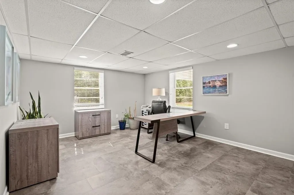 Home office currently locate on terrace or basement level.  Features light tile flooring and lots of natural light.
