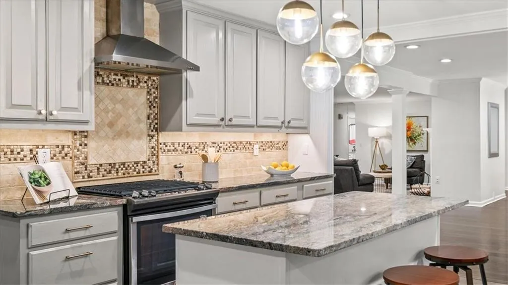 Pendant lighting and recessed lighting is complemented with natural light in this spacious kitchen.