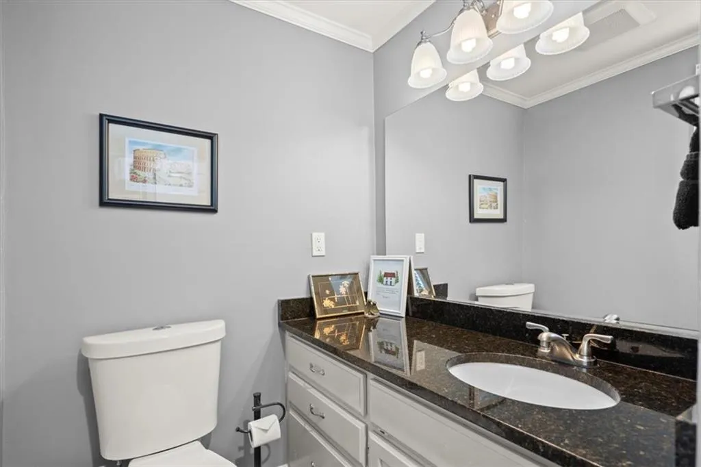 Bathroom featuring ornamental molding, and vanity.