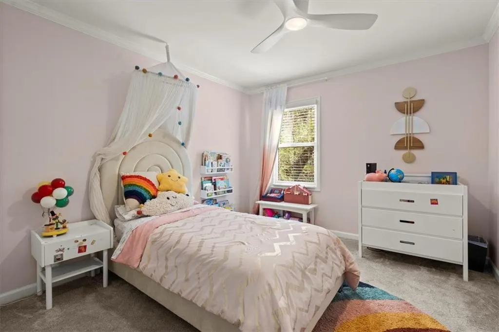 Secondary Bedroom #2 with molding and ceiling fan.