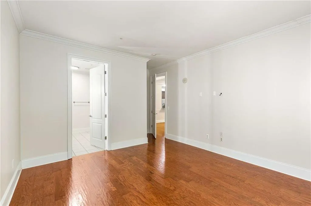 This is a view from the secondary main level bedroom with doors open to the ensuite bathroom and great room.