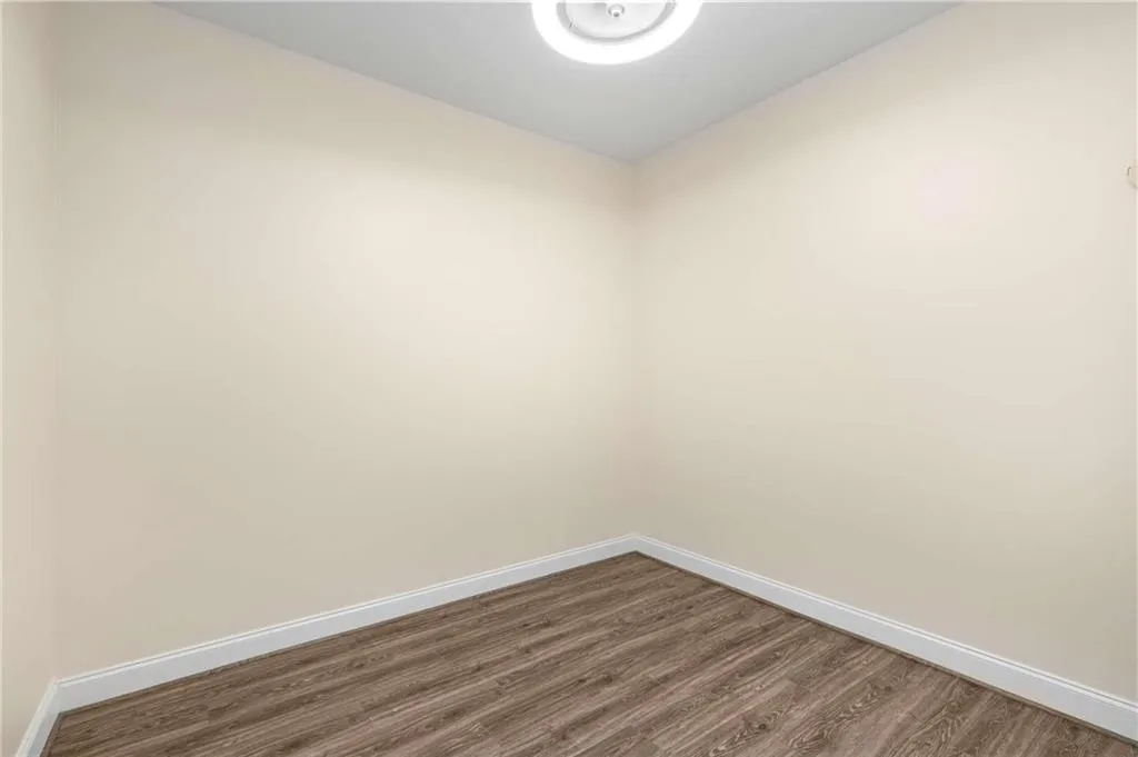 The upstairs bonus room is about 10' x 10'.  It has a ceiling light with a fan in the center with separate controls.