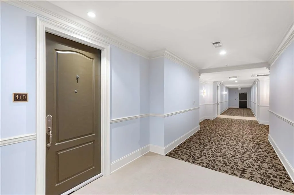 The front door to Suite 410 on the 4th floor hallway.