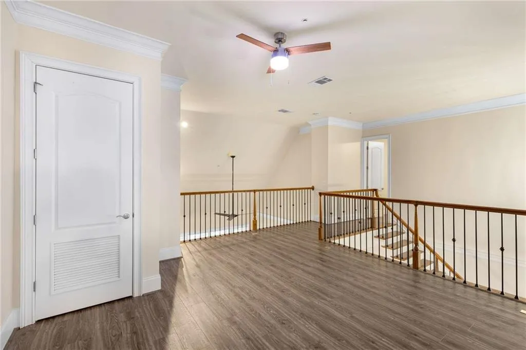 This view of the loft reflects the surprising privacy!  The door on the left opens to the HVAC.  The open door in the background leads to an all purpose bonus room.