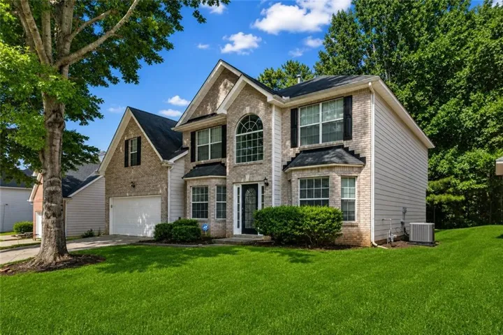 Brick and siding exterior with a two-car garage