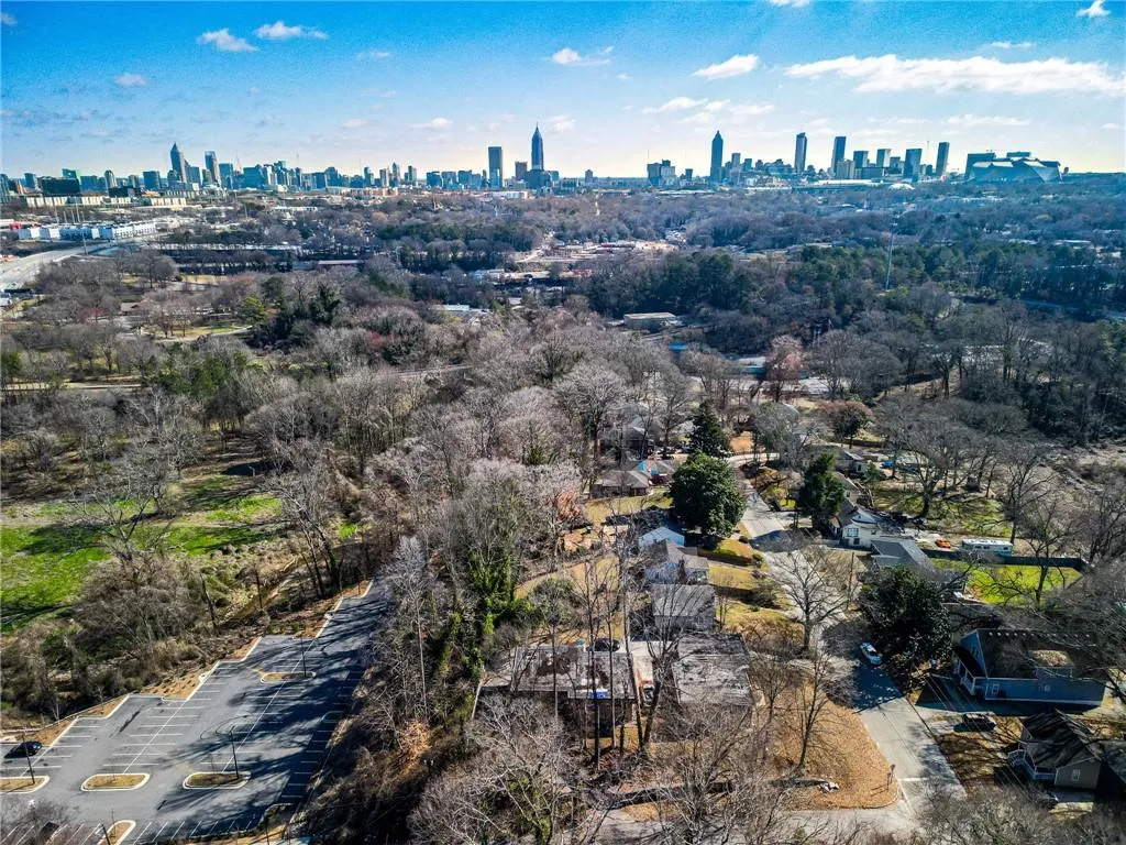 Aerial view of property and surrounding area with city skyline