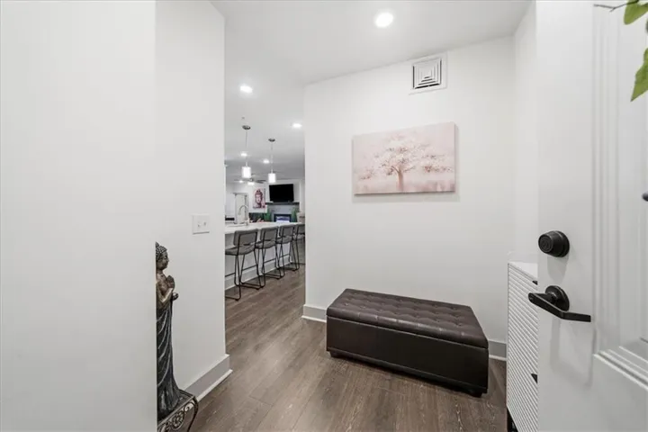 Recessed lighting illuminates the wood-finish flooring