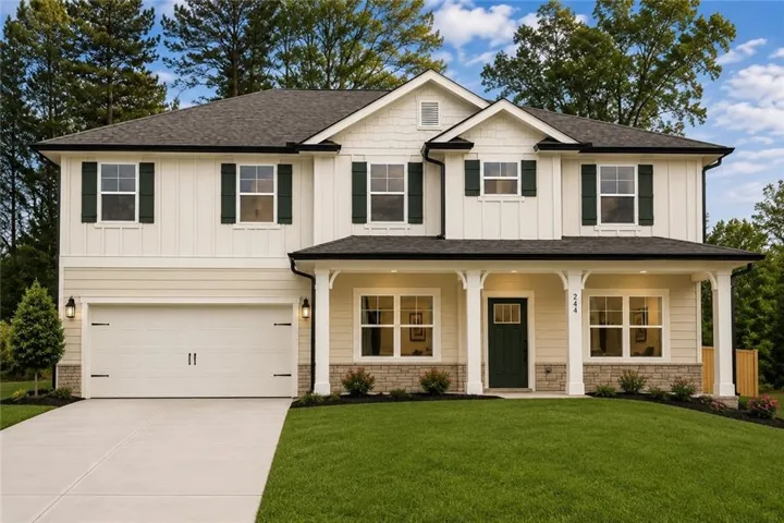 This is a illustration only of finished Floor Plan 2913B.  Two-story residence featuring a covered front porch with white columns, a two-car garage, and dark green shutters