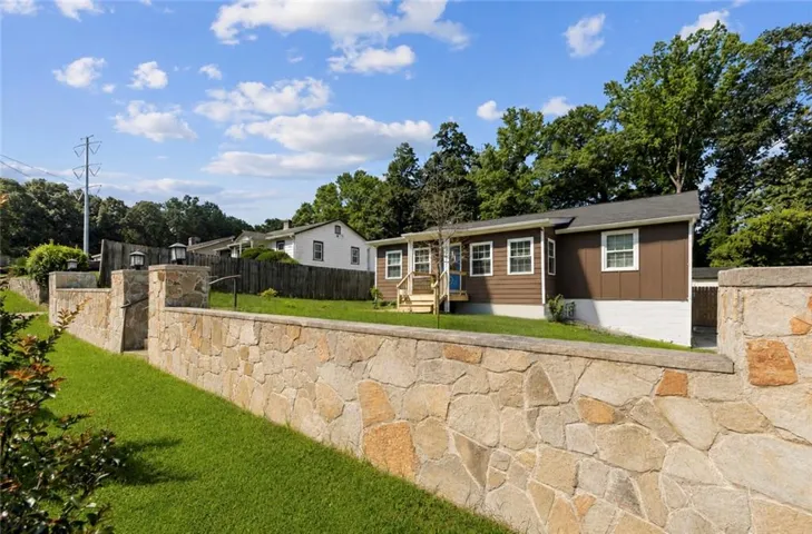 Stone retaining wall with a manicured lawn