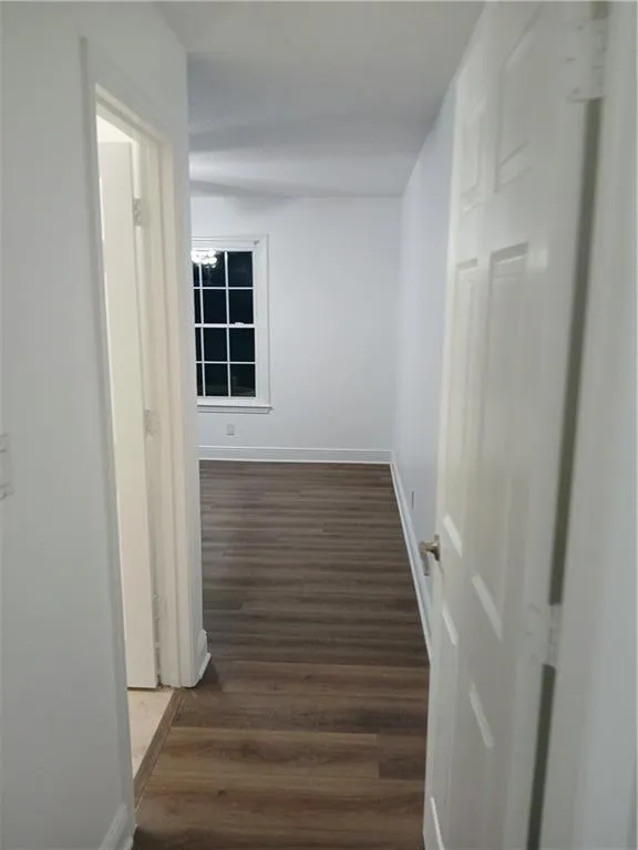 Corridor featuring dark wood-style floors