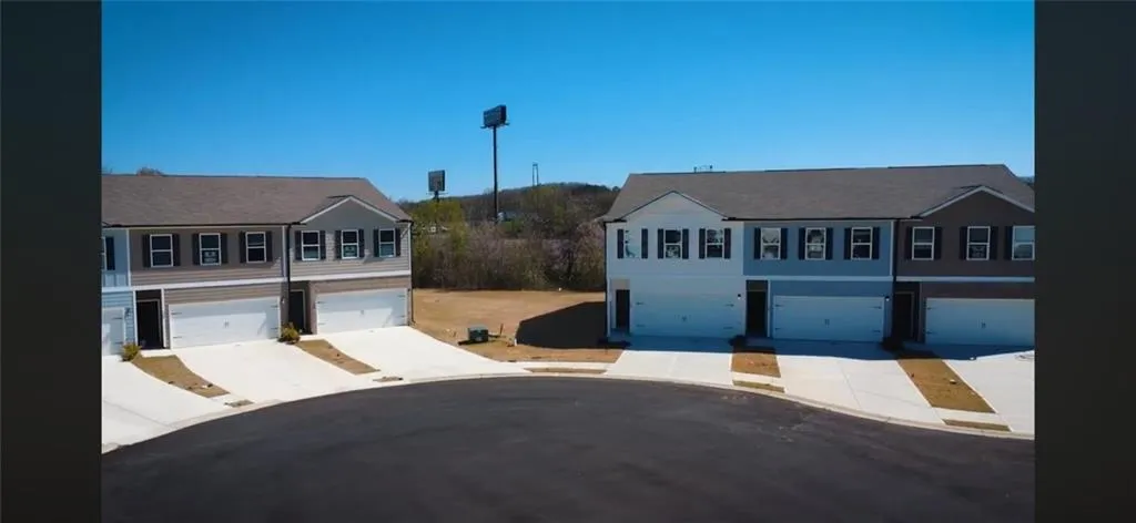 Newly constructed residences featuring two-story designs, attached garages, and a cul-de-sac orientation
