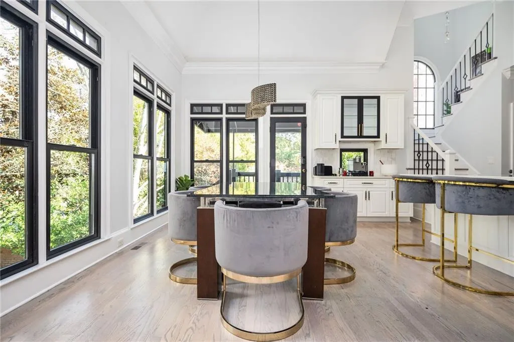 Dining room with crown molding and light hardwood / wood-style flooring