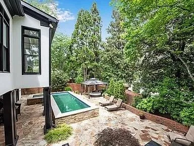 View of swimming pool featuring a gazebo and a patio