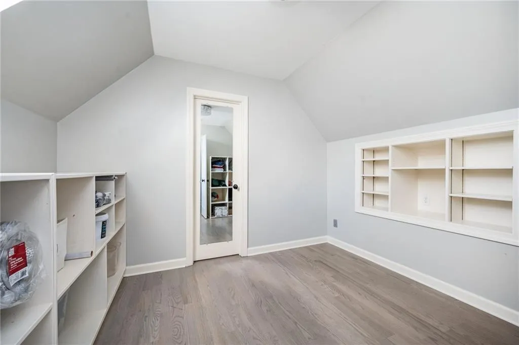 Bonus room featuring wood-type flooring and lofted ceiling