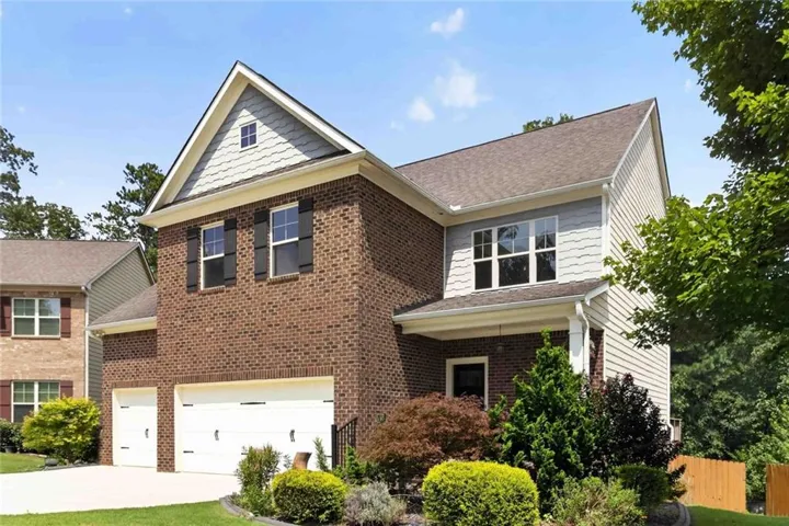 Brick and siding exterior with a two-car garage