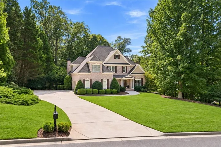 Brick exterior with stone accents and dark shutters