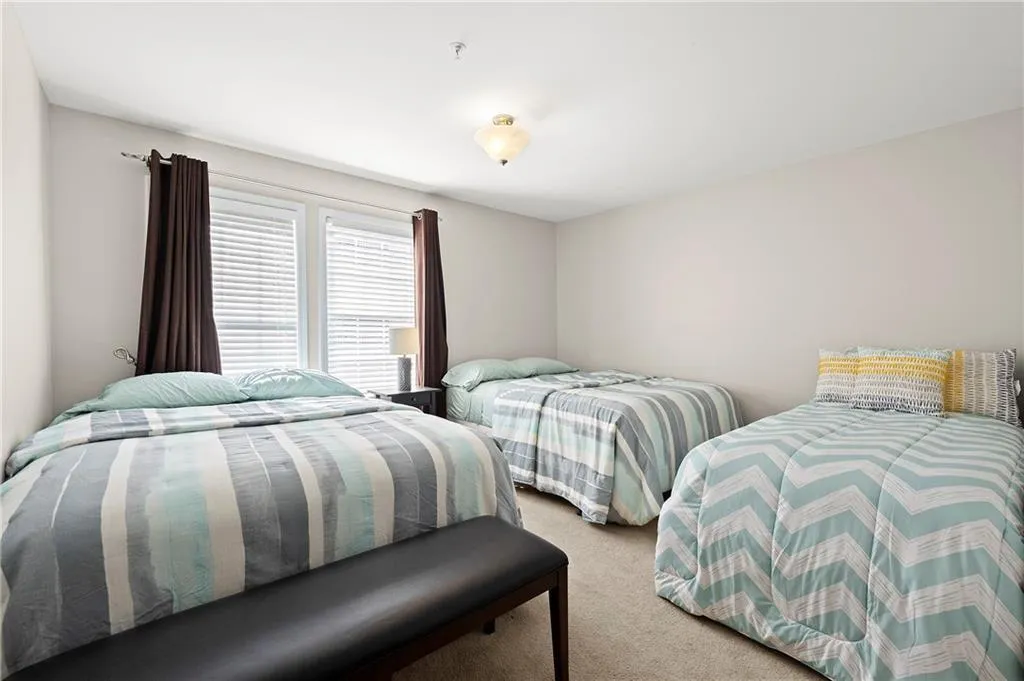 Carpeted interior room featuring light neutral wall paint