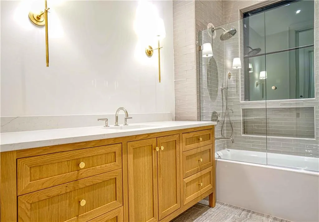 Bathroom with vanity and enclosed tub / shower combo