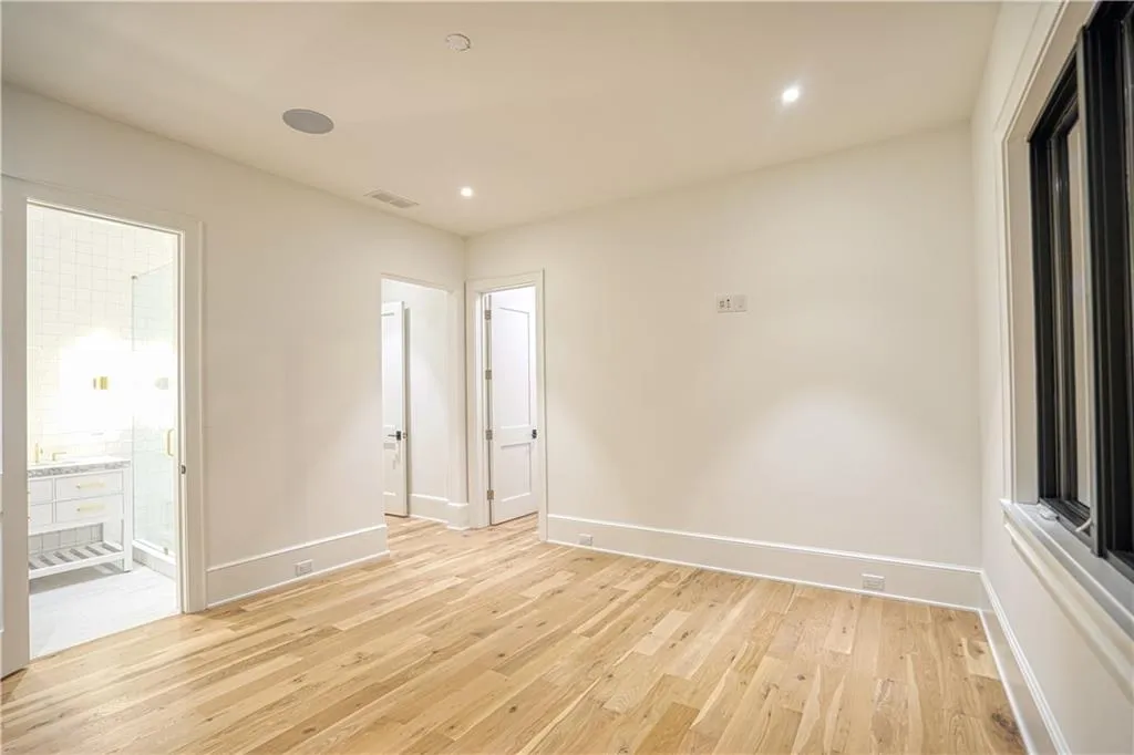 Empty room with light hardwood / wood-style floors