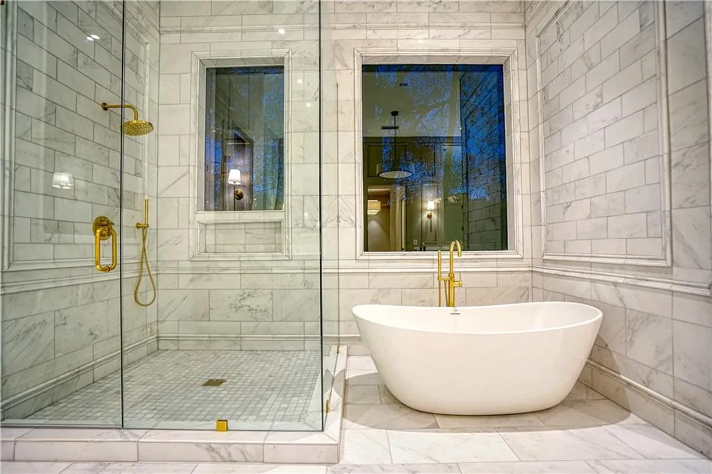 Bathroom featuring independent shower and bath and tile walls