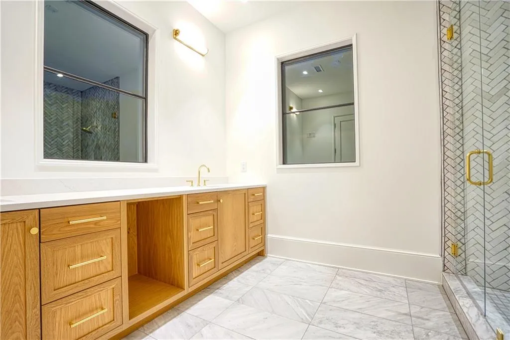 Bathroom featuring walk in shower and vanity