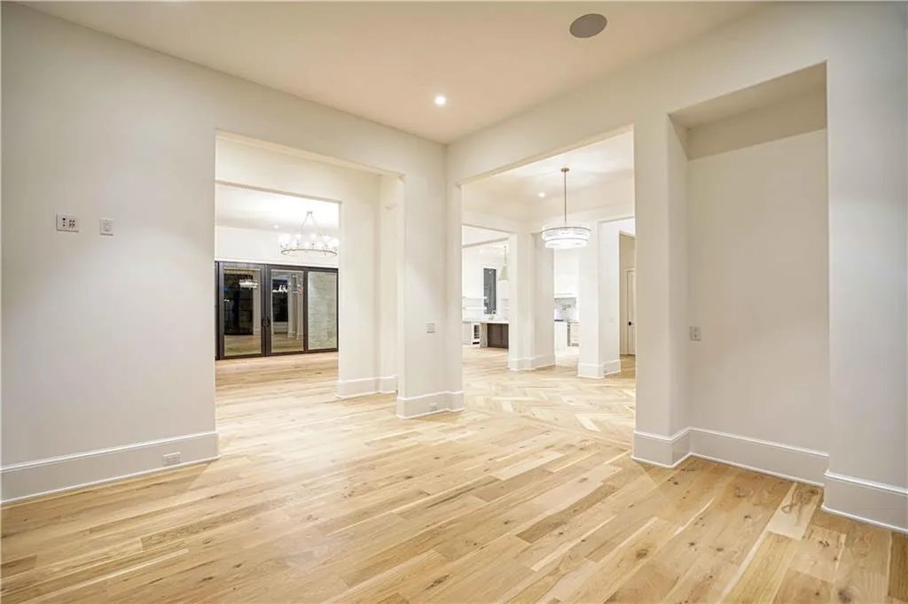 Unfurnished living room with light hardwood / wood-style floors and a chandelier