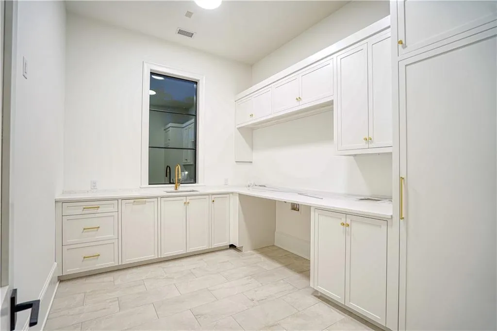 Kitchen with white cabinetry and sink