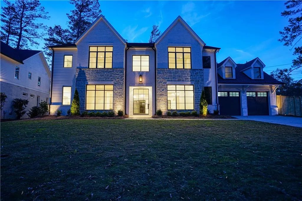 View of front of home featuring a lawn and a garage