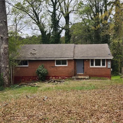 Ranch-style house with brick siding and a front lawn