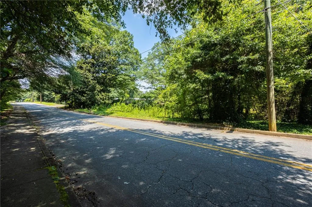 View of asphalt road featuring curbs