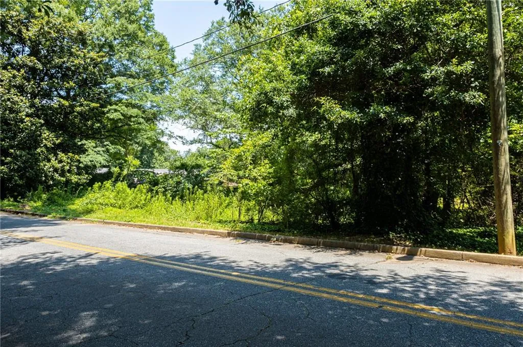 View of asphalt road with curbs