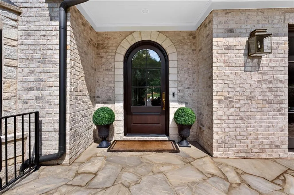New custom front door outlined with custom stonework