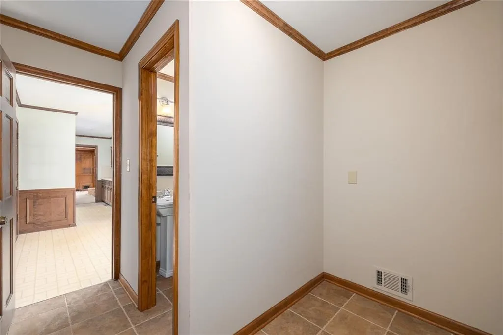 View from the Laundry Room through the Kitchen and into the Family Room. Powder room is on the right.