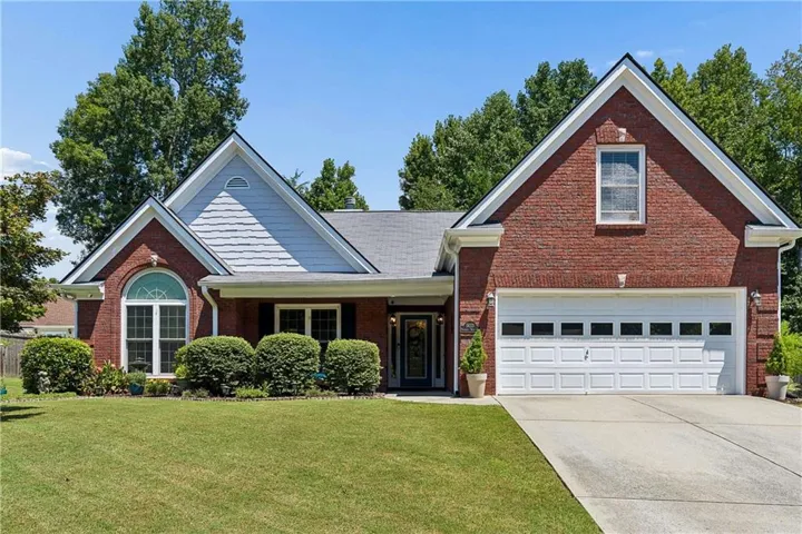 Brick exterior with gabled roof lines and shingle siding accents